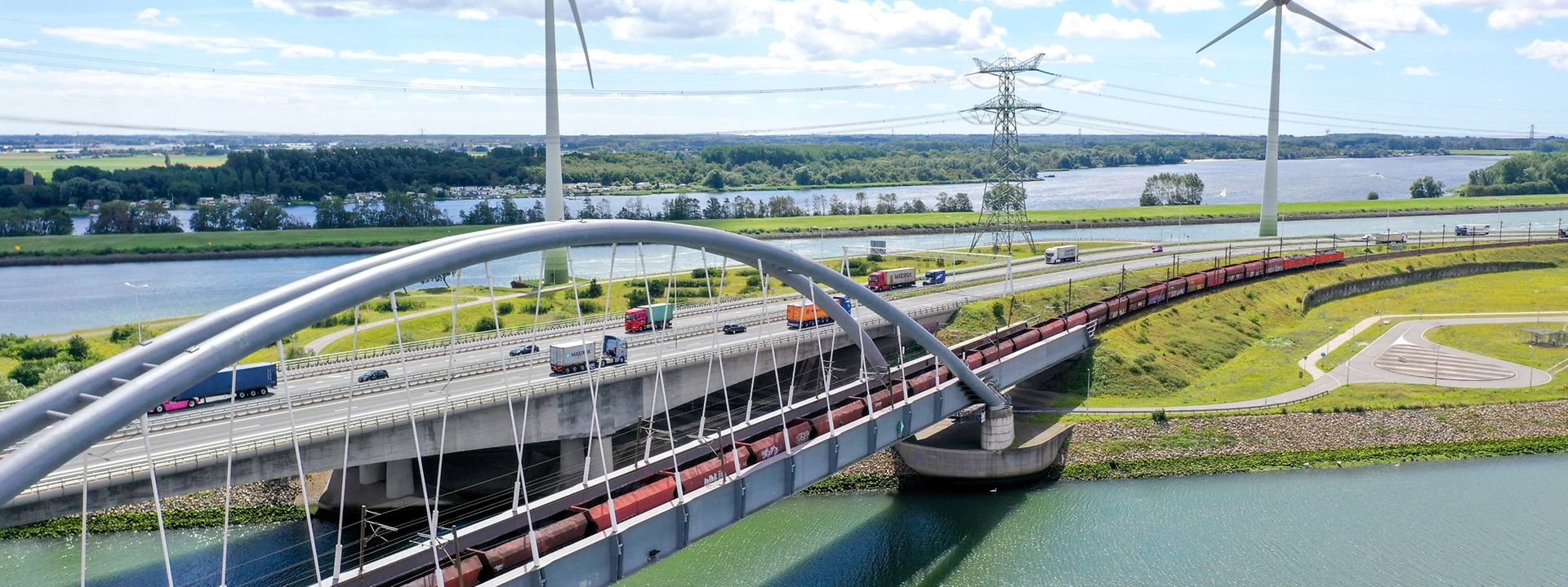 Modern bridge and motorway with wind turbines in the background